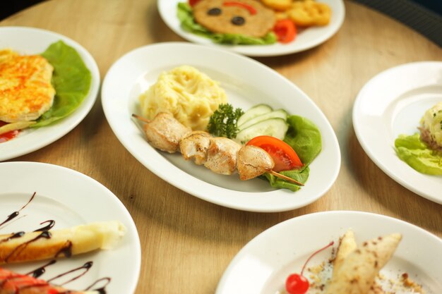 A wide variety of dishes on the table in the restaurant for children