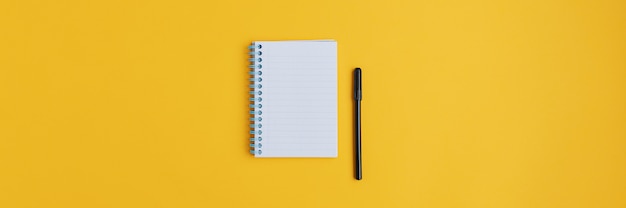 Wide view image of blank spiral note pad and black marker