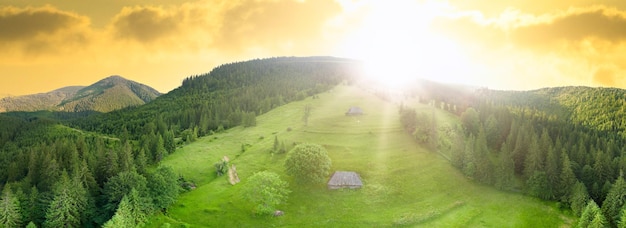 Wideangle panoramic shot of beautiful meadows hills and trees in Synevyrska glade next to Synevyr lake Majestic and wonderful landscapes of the Carpathian mountains in Ukraine