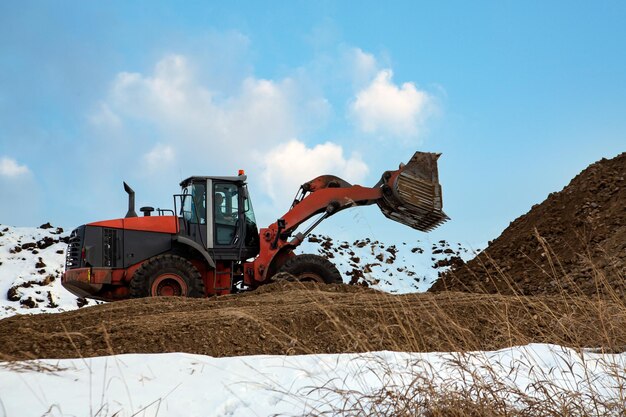 Wiellader graaft grond in de winter