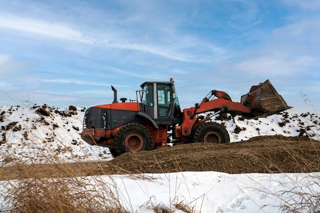 Wiellader graaft grond in de winter