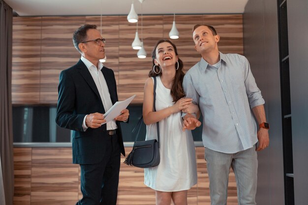 Photo wife feeling amazing while buying new apartment with husband