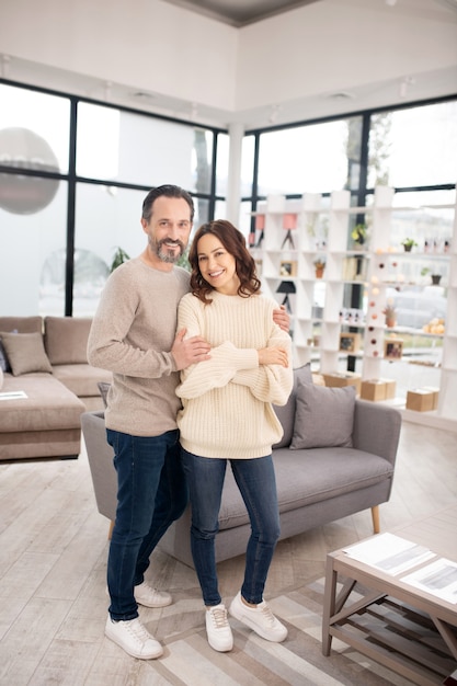 Wife and husband standing in a light room