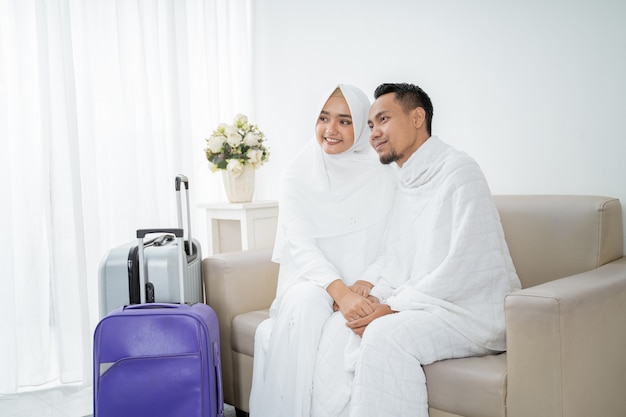 Wife and husband in white traditional clothes for Ihram