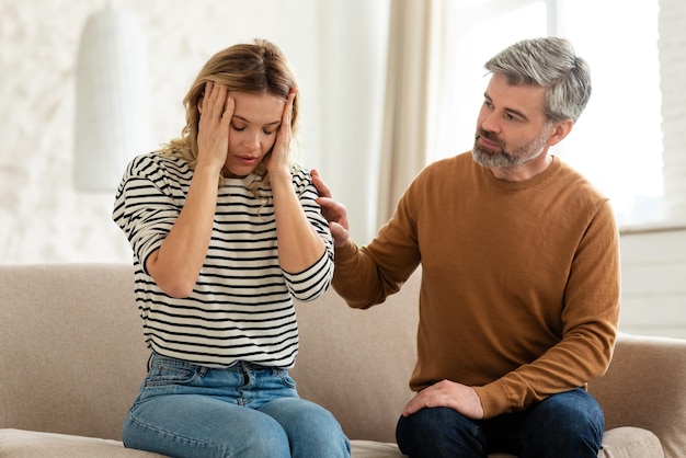 Wife suffering from headache husband caring for her at home