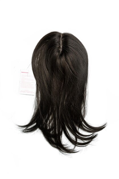 Photo a wig of dark hair on a white isolated background