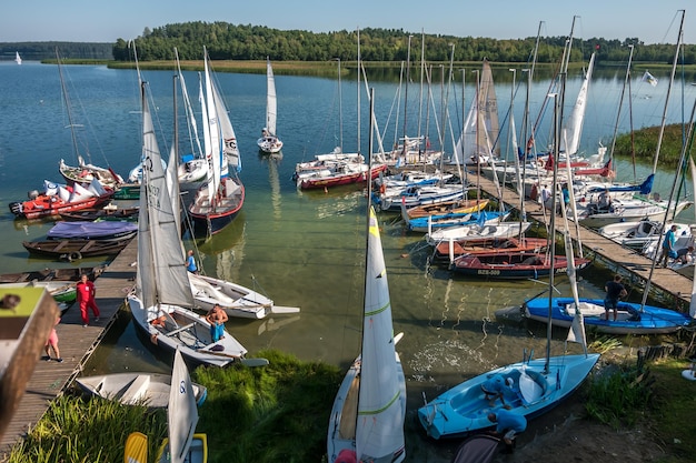 WIGRY POLAND AUGUST 2019 many yachts stand on the pier and prepare for the regatta