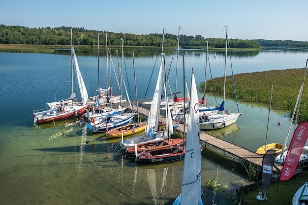 WIGRY POLAND AUGUST 2019 many yachts stand on the pier and prepare for the regatta