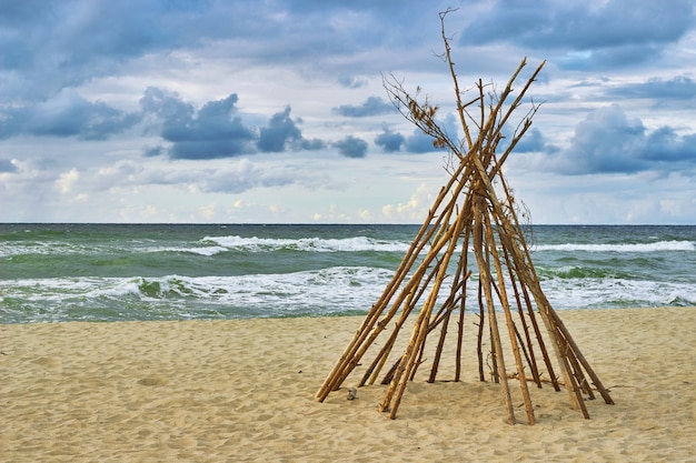 Wigwam on the beach. Abandoned hut.