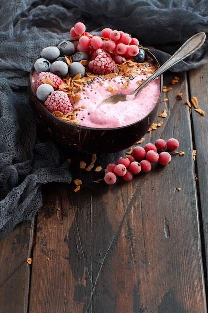 Wild berries smoothie bowls topped with frozen berries and\
granola
