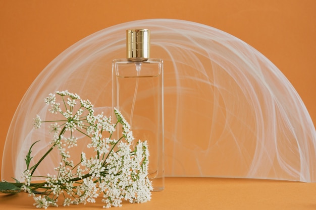 wild flower and bottle of porphoma on brown background