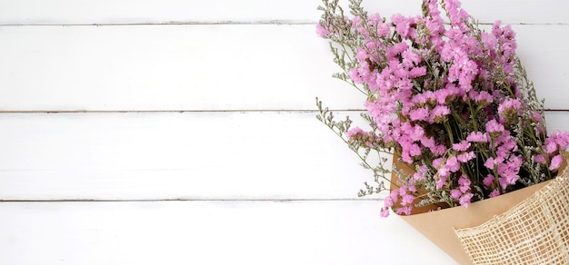 Wild flower bouquet on vintage white wood background