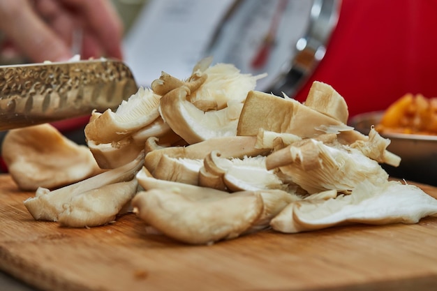 Wild mushrooms on wooden cutting board in home kitchen