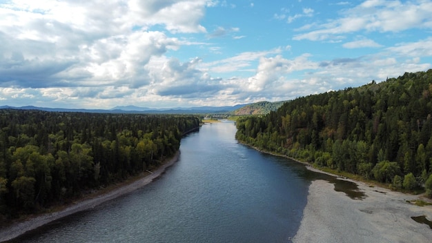 Wild nature landscape drone view with river and forest. Mountain Siberian river flow, water on stone