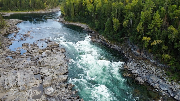 Wild nature landscape drone view with river and forest. Mountain Siberian river flow, water on stone