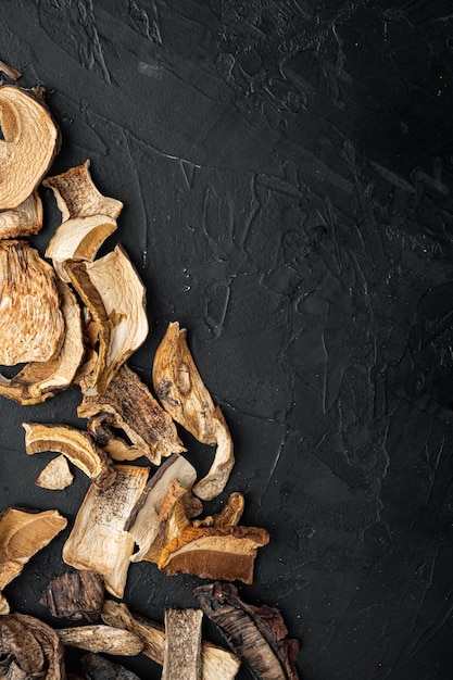 Wild organic dried porcini mushroom on black top view flat lay 