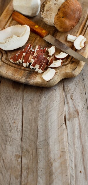 Wild porcino mushrooms on a wooden board close up