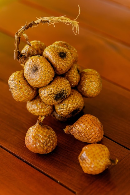 Wild salak fruit on wooden table