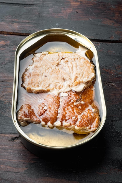 Wild Trout Canned smoked fish in tin can on old dark wooden table backgroundxA