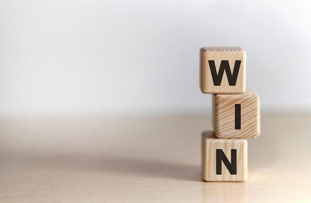 WIN - text on wooden cubes, on white background