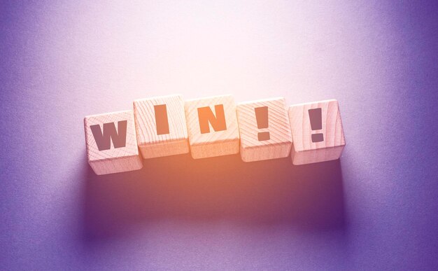 Win Word Written on Wooden Cubes