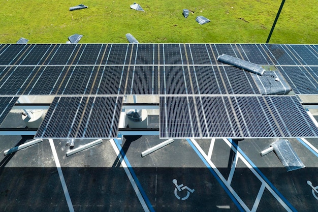 Wind damage to solar panels installed over parking lot canopy shade for parked cars for effective generation of clean energy