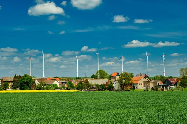 Wind electric turbines in agricultural wheat field in countryside Deutchland