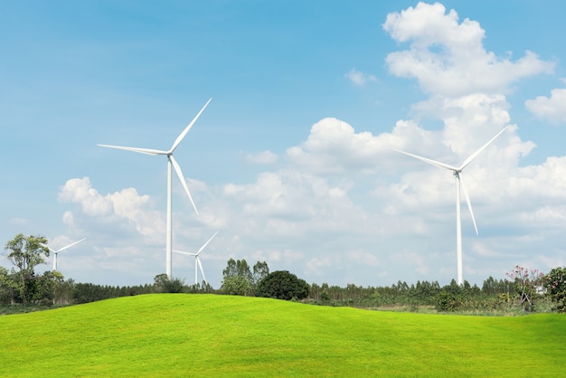 Wind Turbine for alternative energy with green grass fields foreground. 