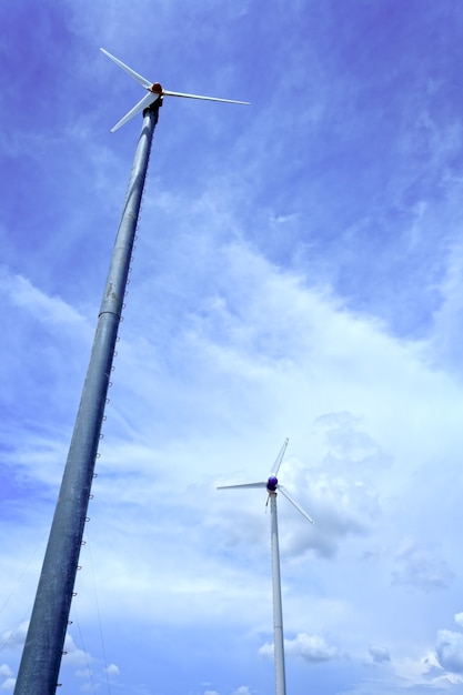 Wind turbine and clouds in blue sky