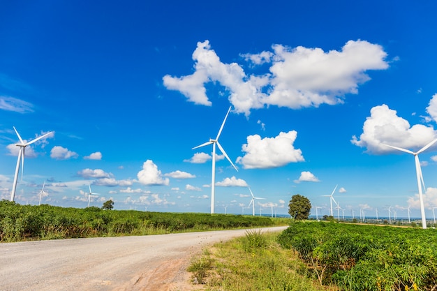 Wind turbine farm in beautiful nature with blue sky blackground, generating electricity 