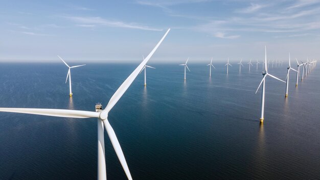Photo wind turbine from aerial view drone view at windpark westermeerdijk a windmill farm in the lake ijsselmeer the biggest in the netherlandssustainable development renewable energy