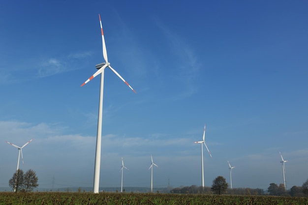 wind turbine  generating eco friendly renewable  electricity energy on blue sky