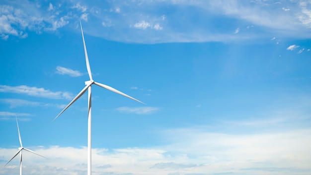 A wind turbine is shown against a blue sky.