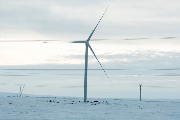 Wind Turbine in winter landscape. Alternative energy sources. Eco-friendly electricity green energy