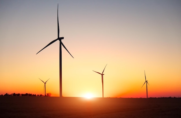 Wind turbines and agricultural field on a summer day Energy production clean and renewable energyxA