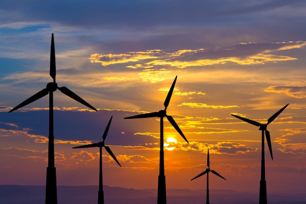 The wind turbines on the background of a sunset