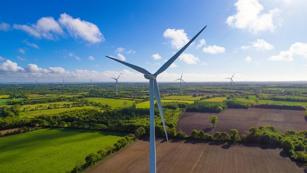 Wind turbines on field against sky