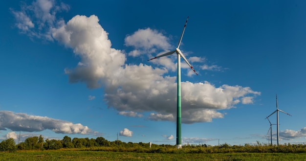 Wind turbines in the field on a background of beautiful sky with clouds, panoramic view