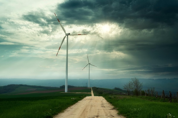 Wind turbines on the field with dramatic sky