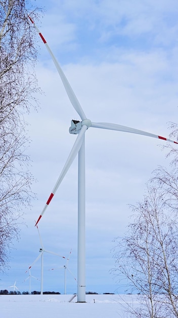 Wind turbines on a frosty winter day in a snowy field