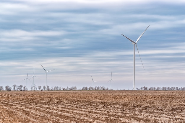 Wind turbines generating electricity in a field