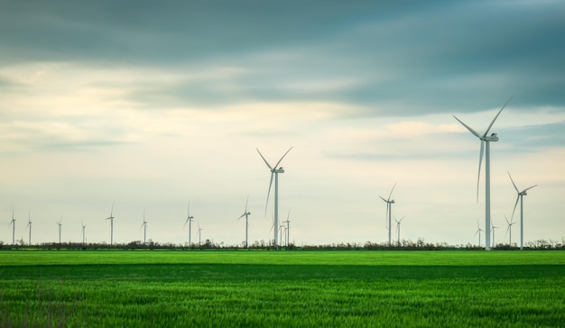 Wind turbines generating electricity with blue sky energy conservation concept