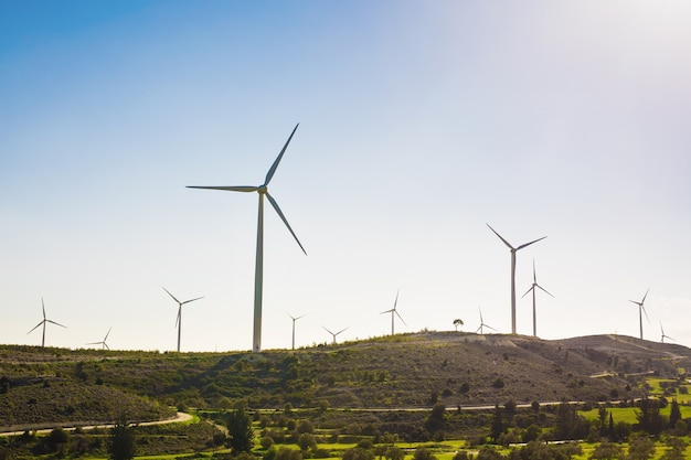 Wind turbines generating electricity with blue sky - energy conservation concept.