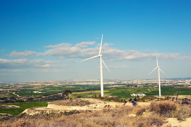 Wind turbines generating electricity with blue sky - energy conservation concept.