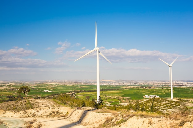 Wind turbines generating electricity with blue sky - energy conservation concept.