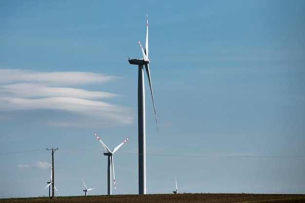 Wind turbines on green hills Group of windmills for electric power production in the green