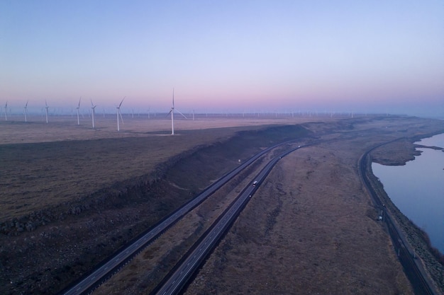 Wind turbines on the horizon with a pink sky in the background