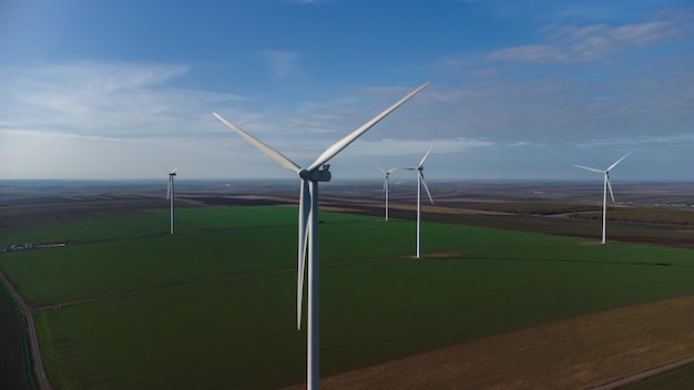 Wind turbines standing in the field from the drone point of view