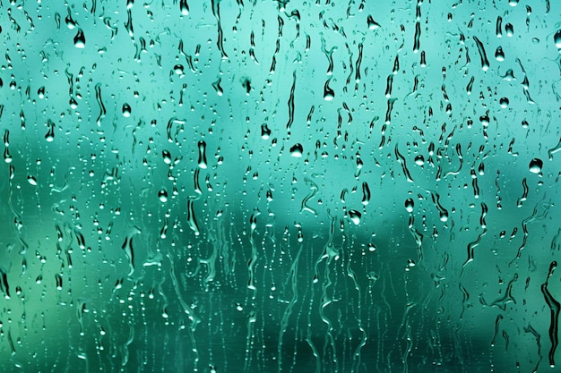 Windblown rain creating abstract patterns against a windowpane