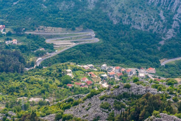 A winding asphalt road leads to the top of the mountain